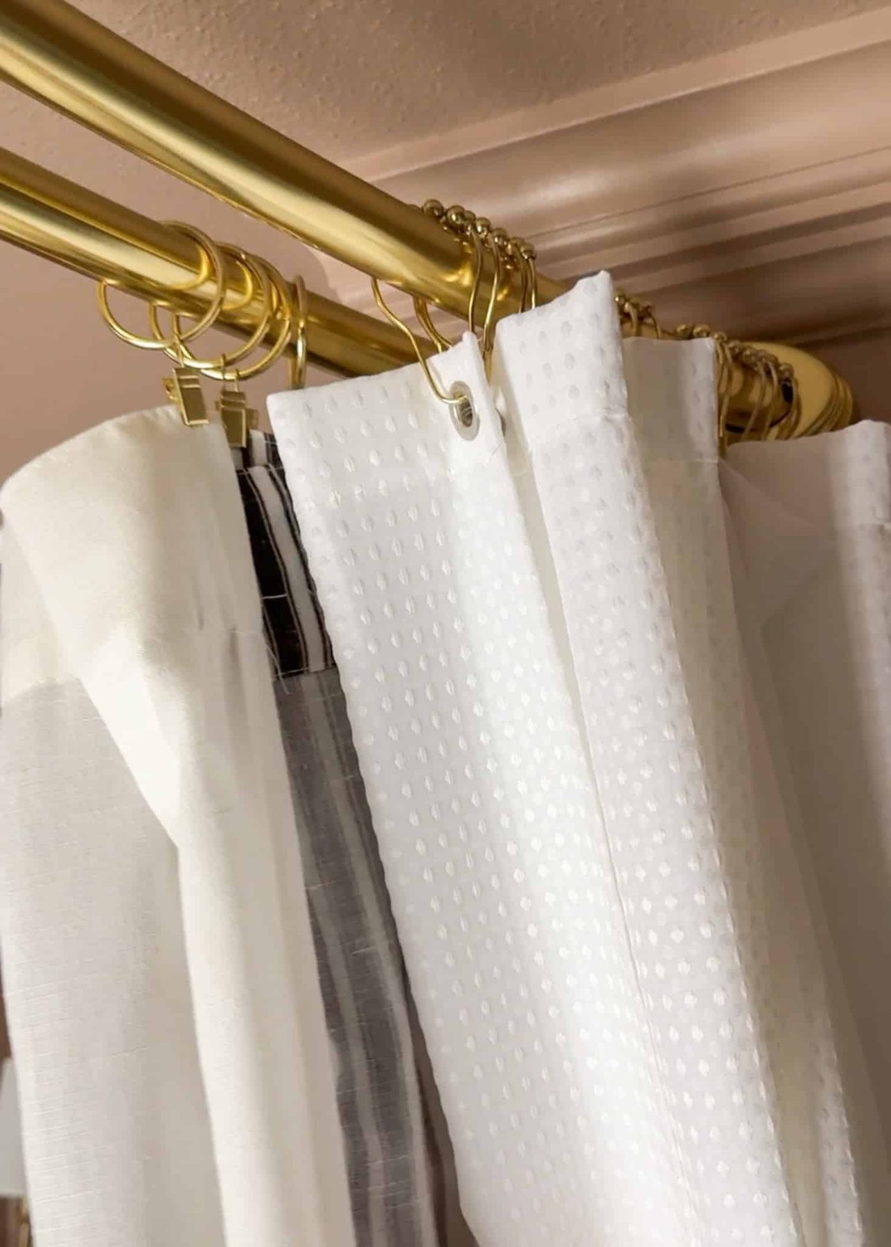 hanging extra long shower curtain liner on a curtain rod
