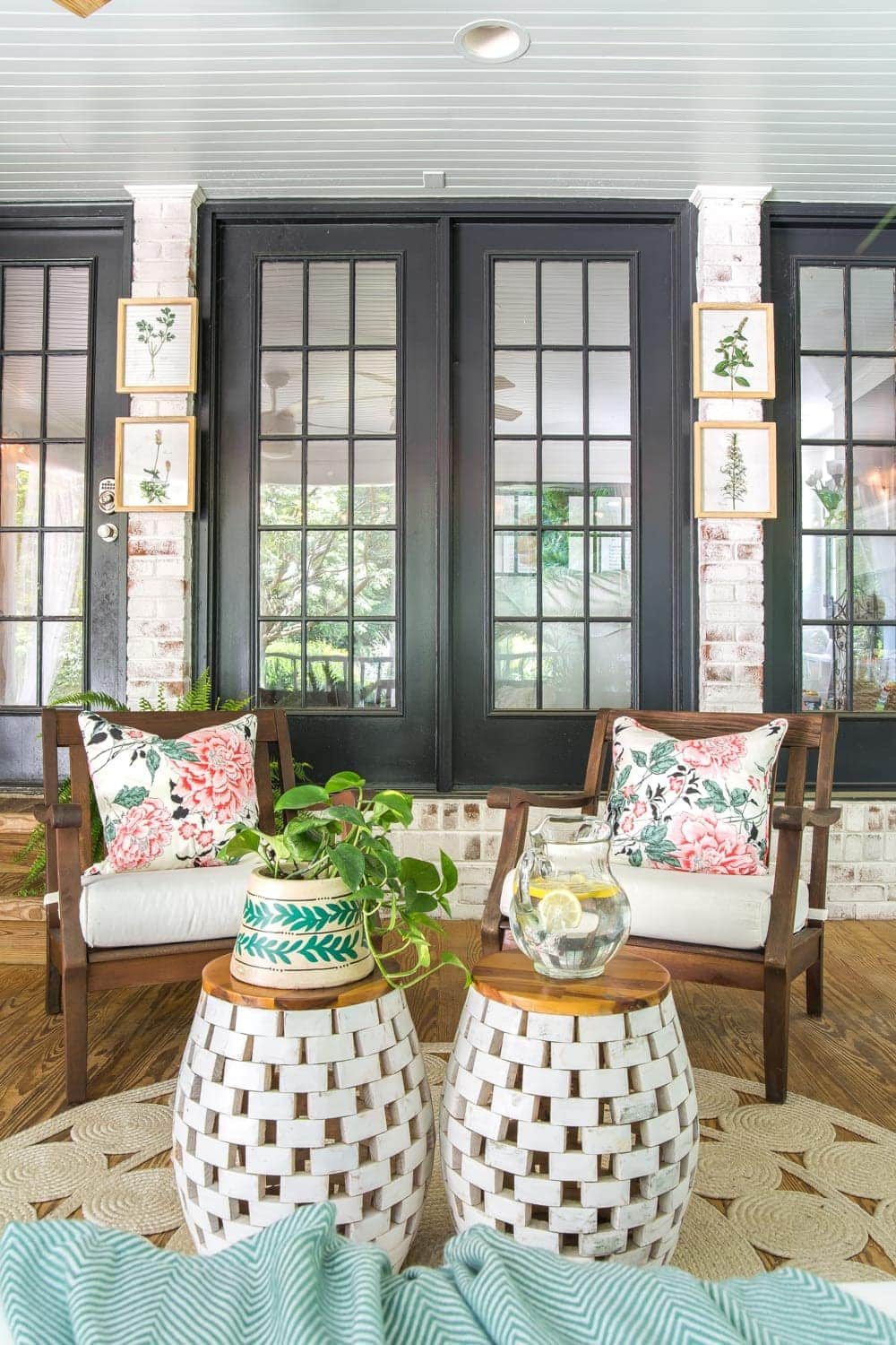 A tropical boho back porch decorated for summer with breezy, functional style from Walmart's Flower Home line by Drew Barrymore and string lights for evening ambience. #backporch #summerdecor