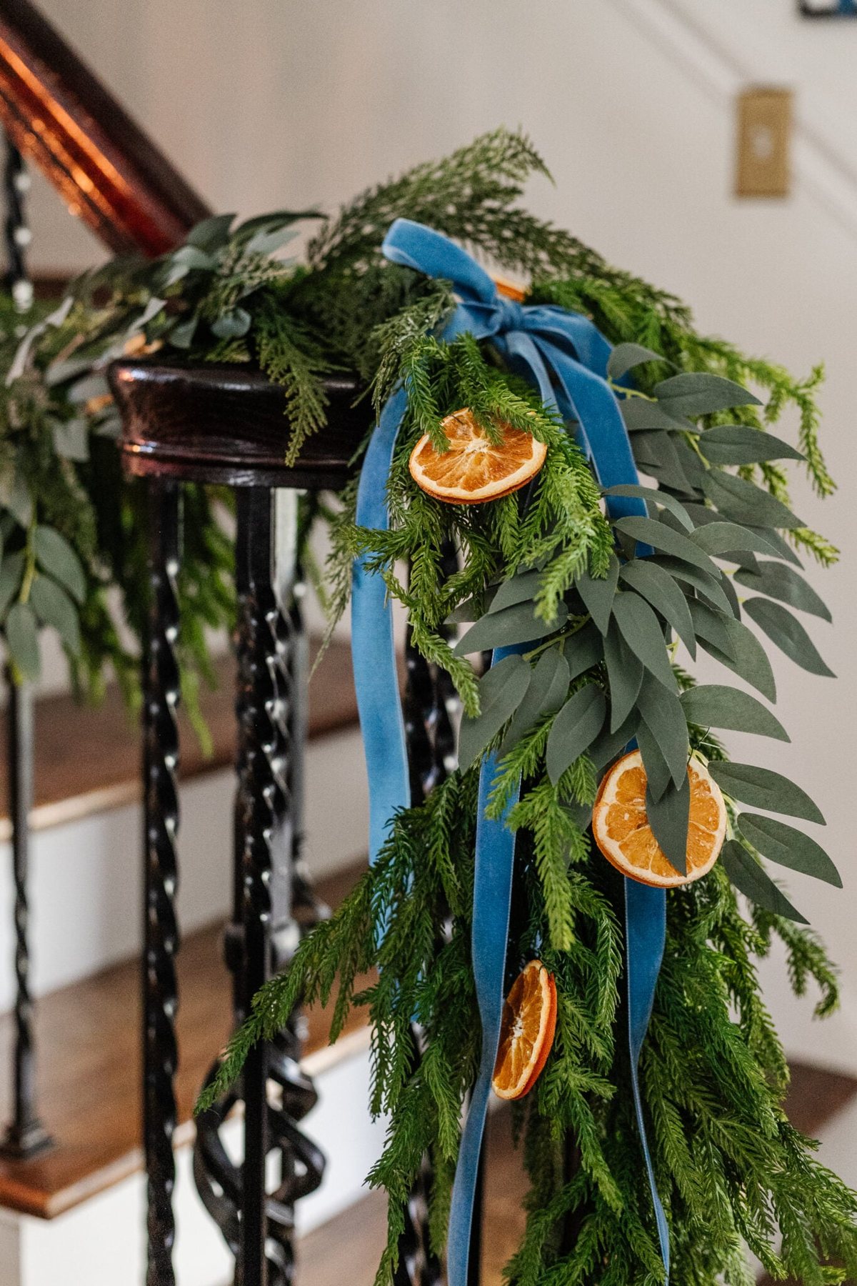 garland with dried oranges, eucalyptus, and blue ribbon