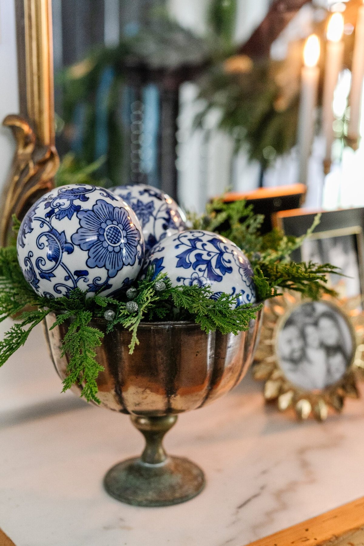 porcelain orbs in a footed bowl with greenery for blue and white Christmas decor