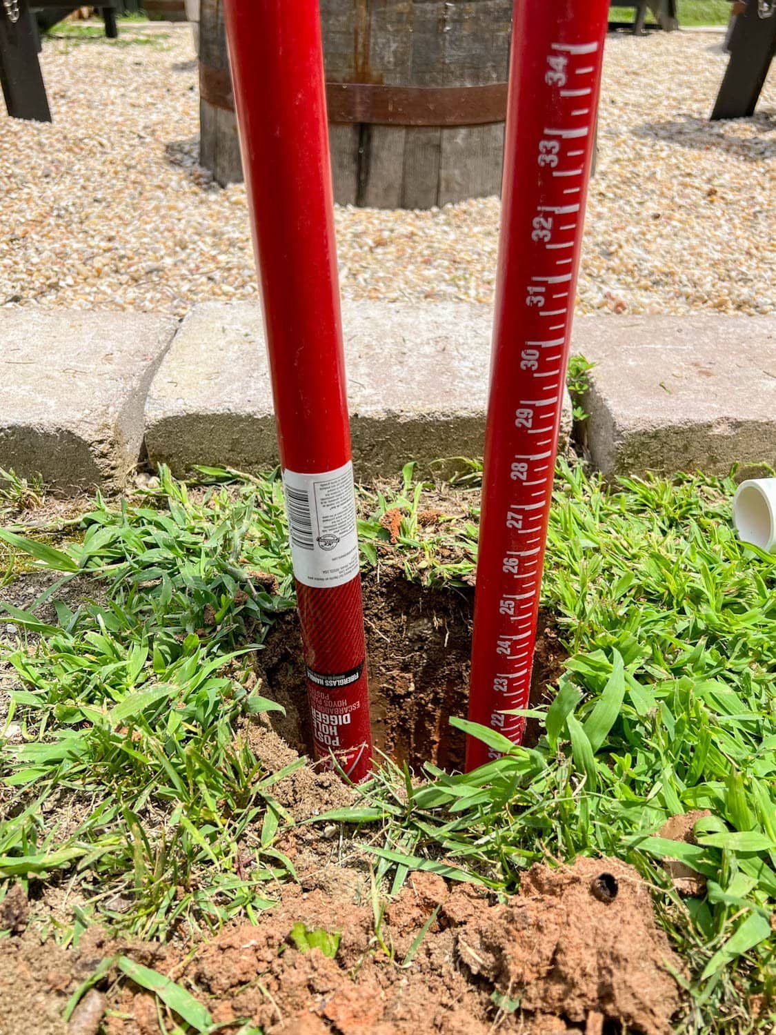 a post hole digger in a hole 2 feet deep