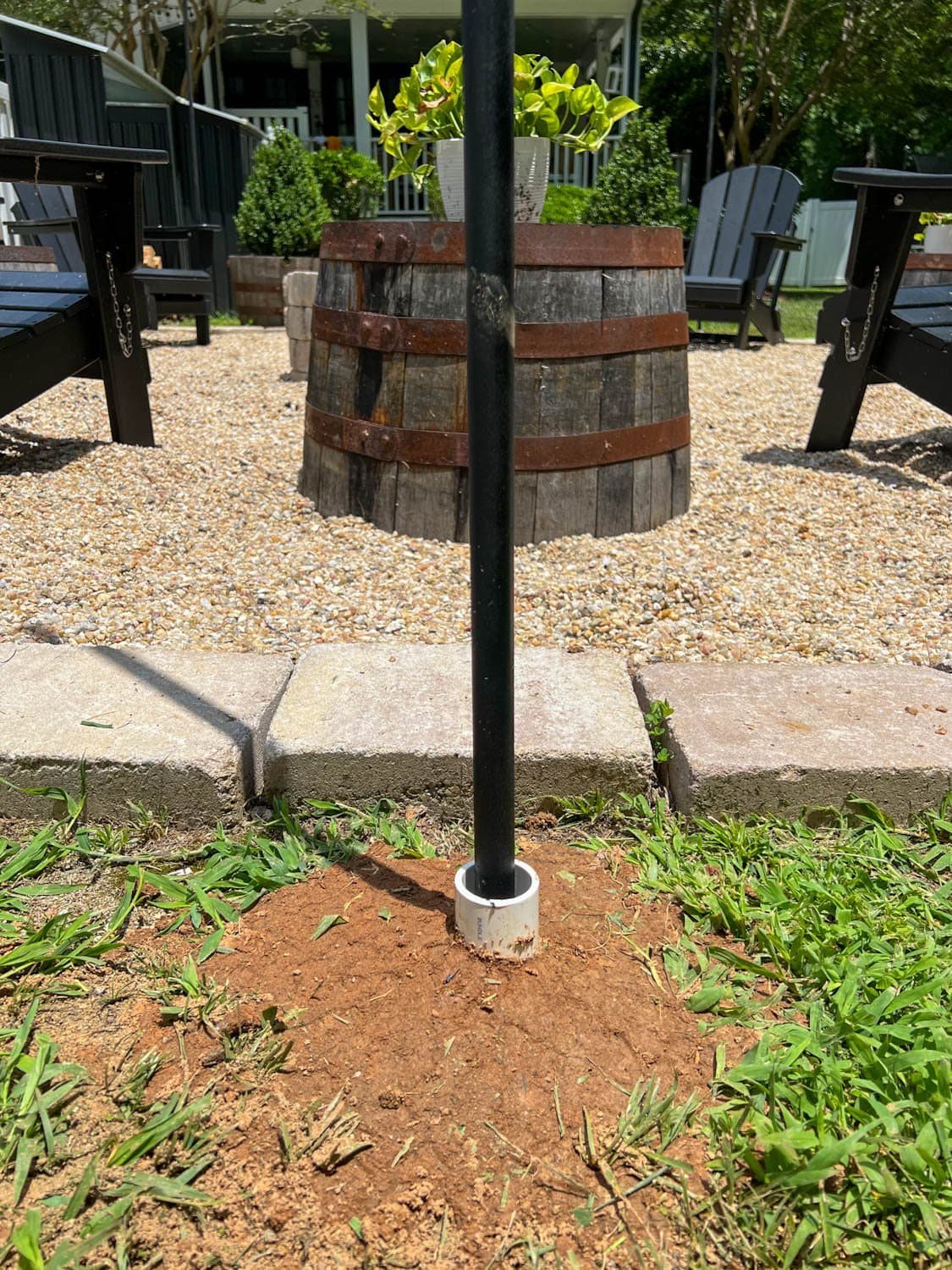 DIY string light pole in the ground with PVC pipe to anchor it