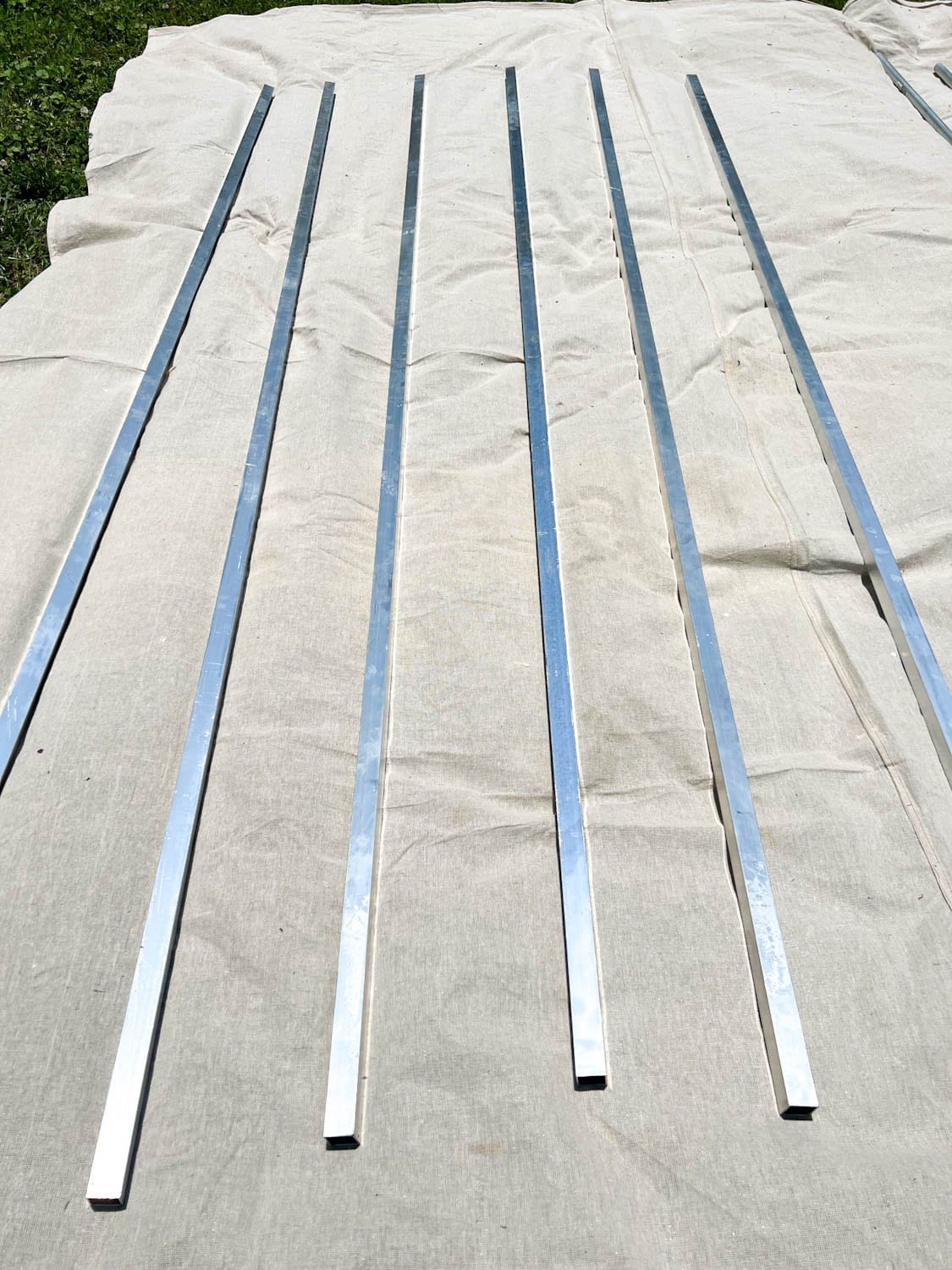 square aluminum tubing on a drop cloth to be painted