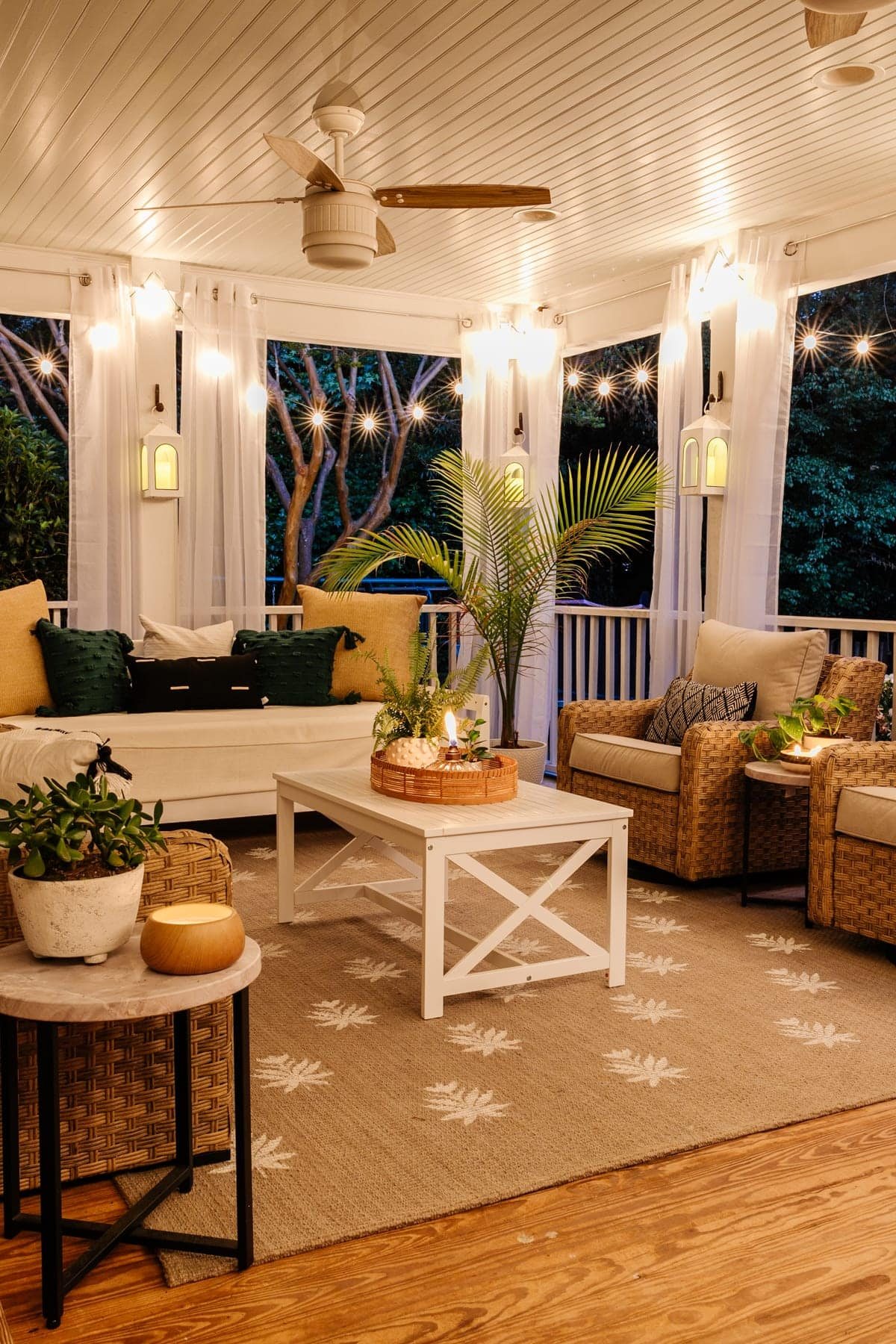 back porch at night with twinkle lights, candles, and floral block DIY outdoor rug
