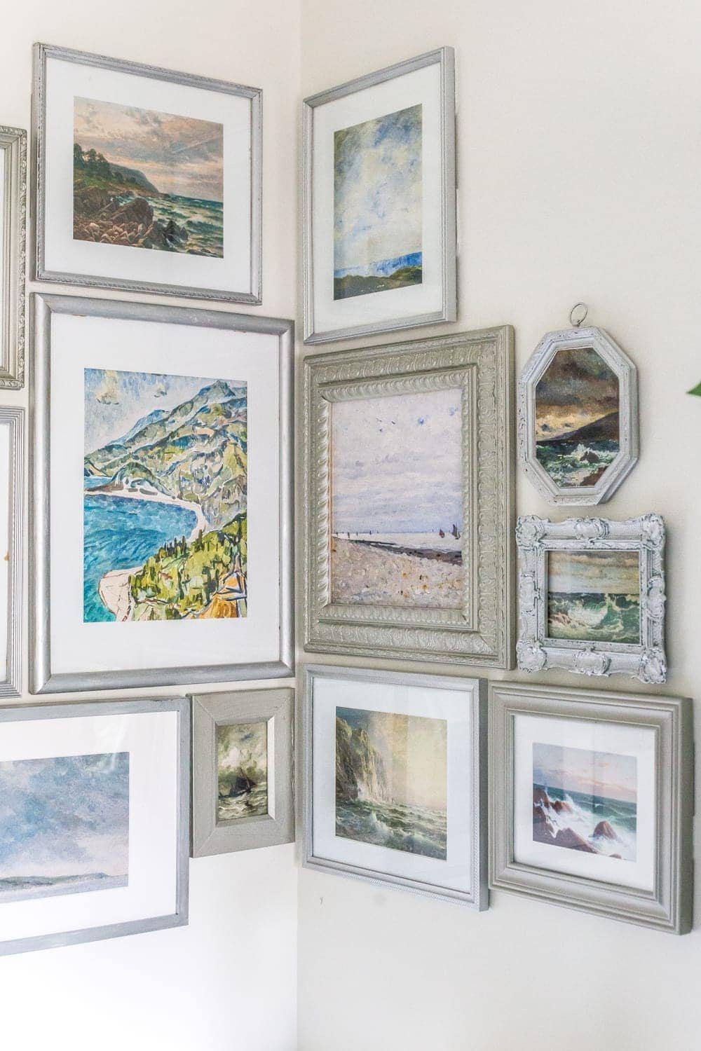 thrifted gallery wall with coastal art