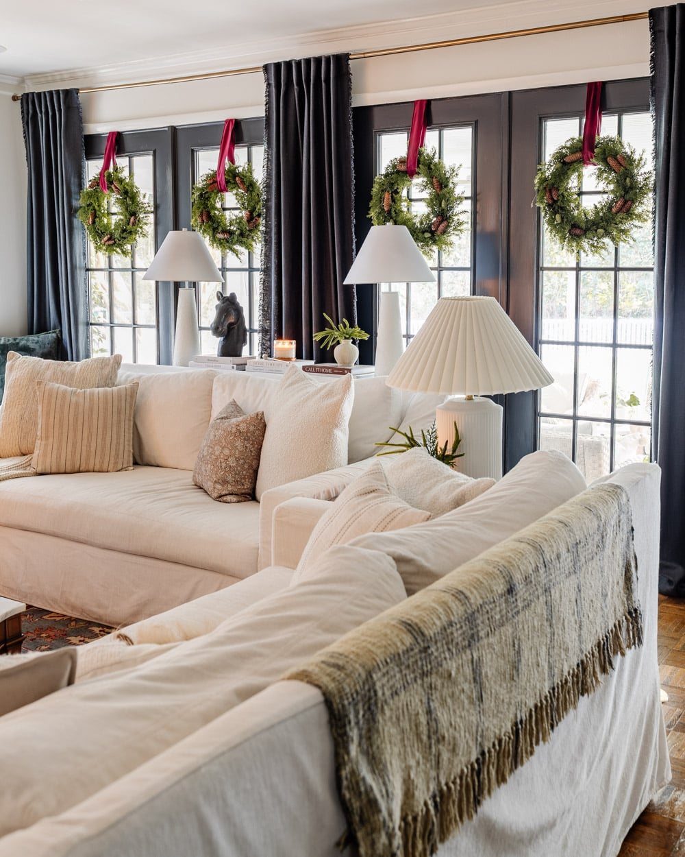 wreaths on windows for Christmas in a living room