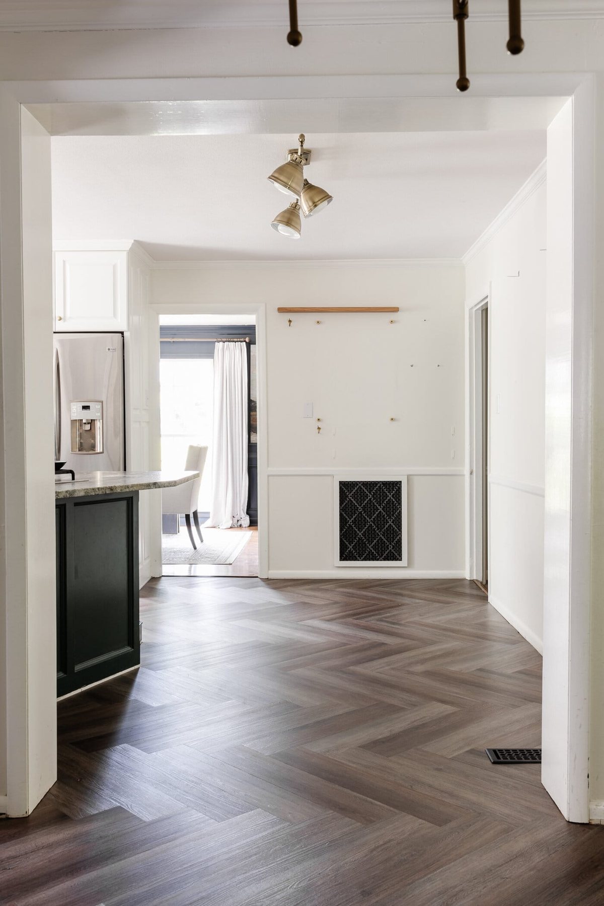 finished ProCore Floor herringbone LVP floating floor over tile in a kitchen