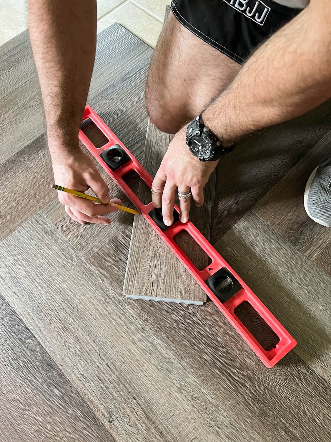 marking measurements on a piece of LVP to cut and fit