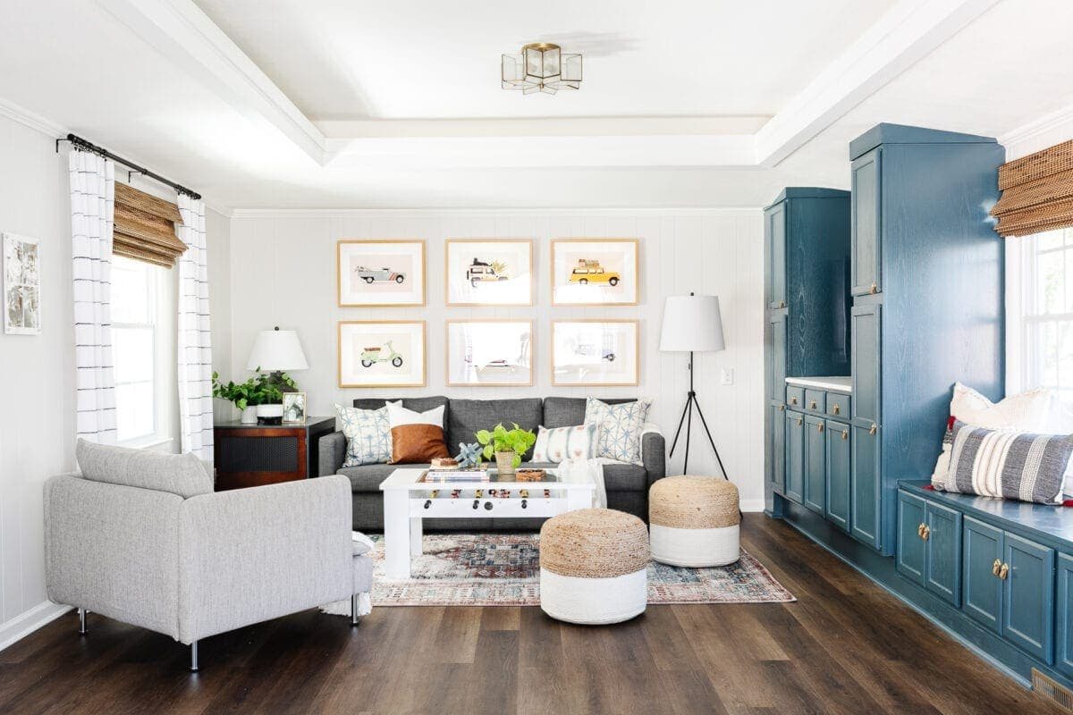 rec room playroom with blue cabinets, sofa, and foosball table with LVP flooring