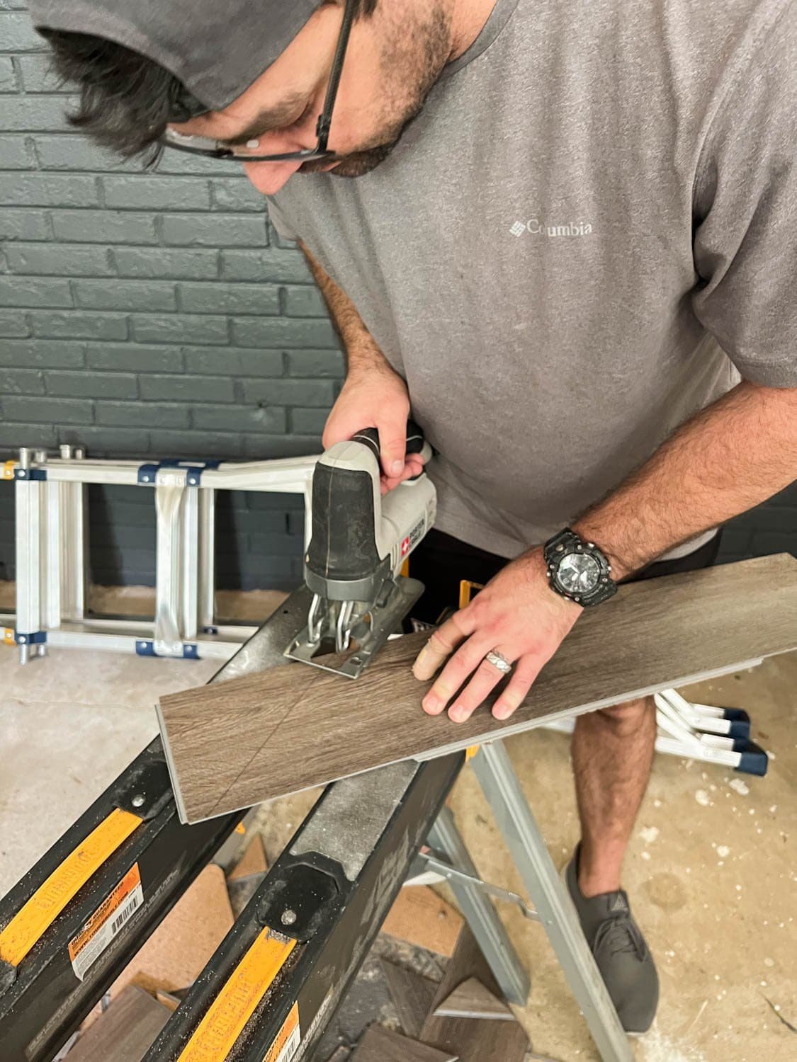cutting a piece of LVP floor with a jigsaw