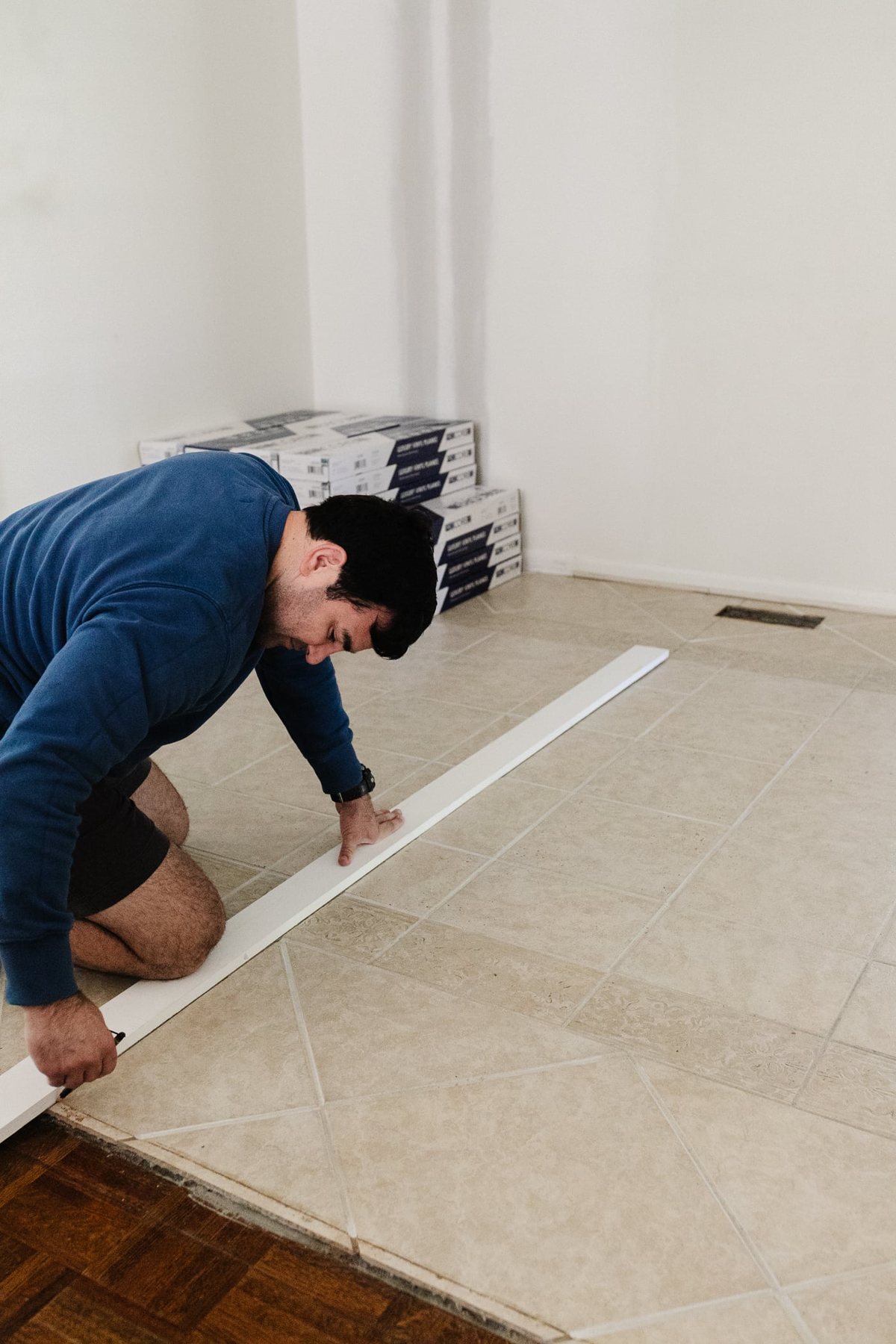 marking the starting line to install LVP floating floor over tile
