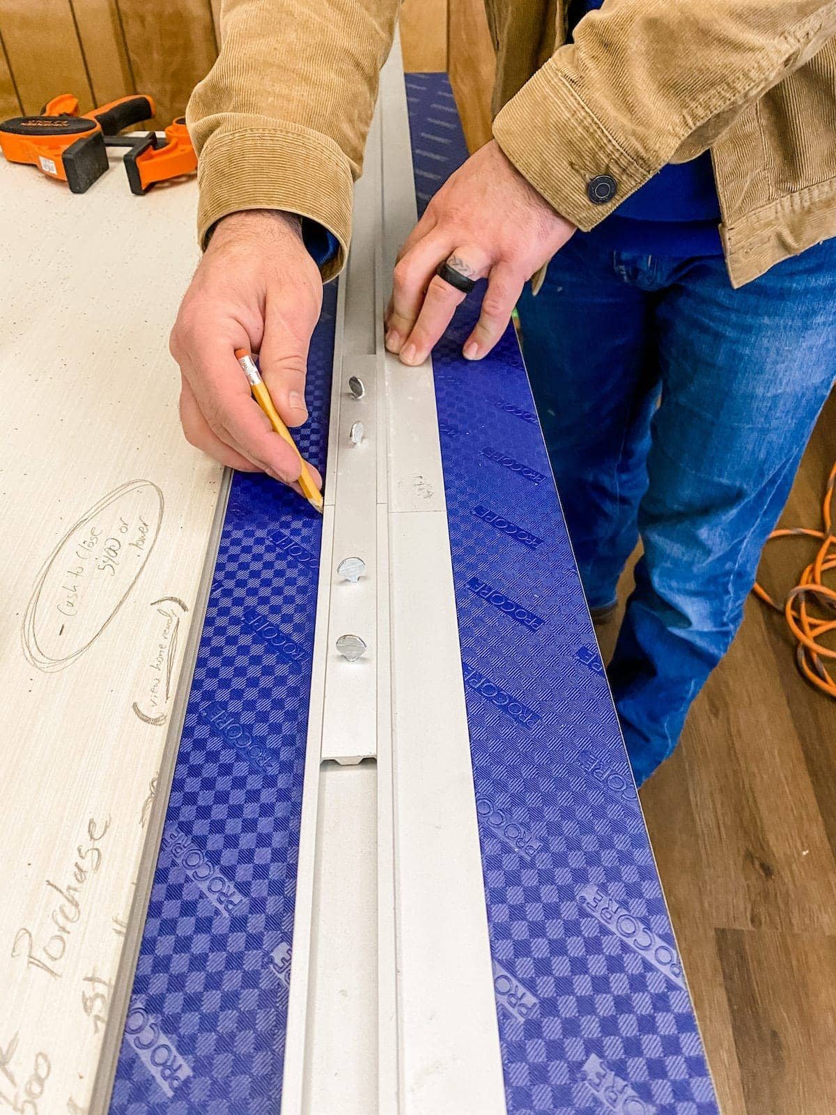 Using a straight edge to cut luxury vinyl plank flooring