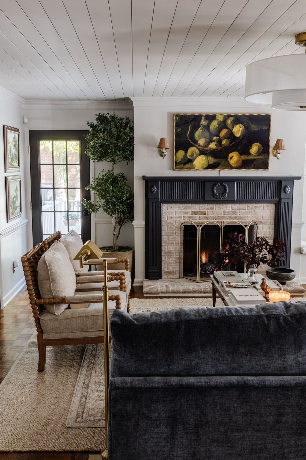 living room with blue fireplace mantel, marble coffee table, and modern fandelier