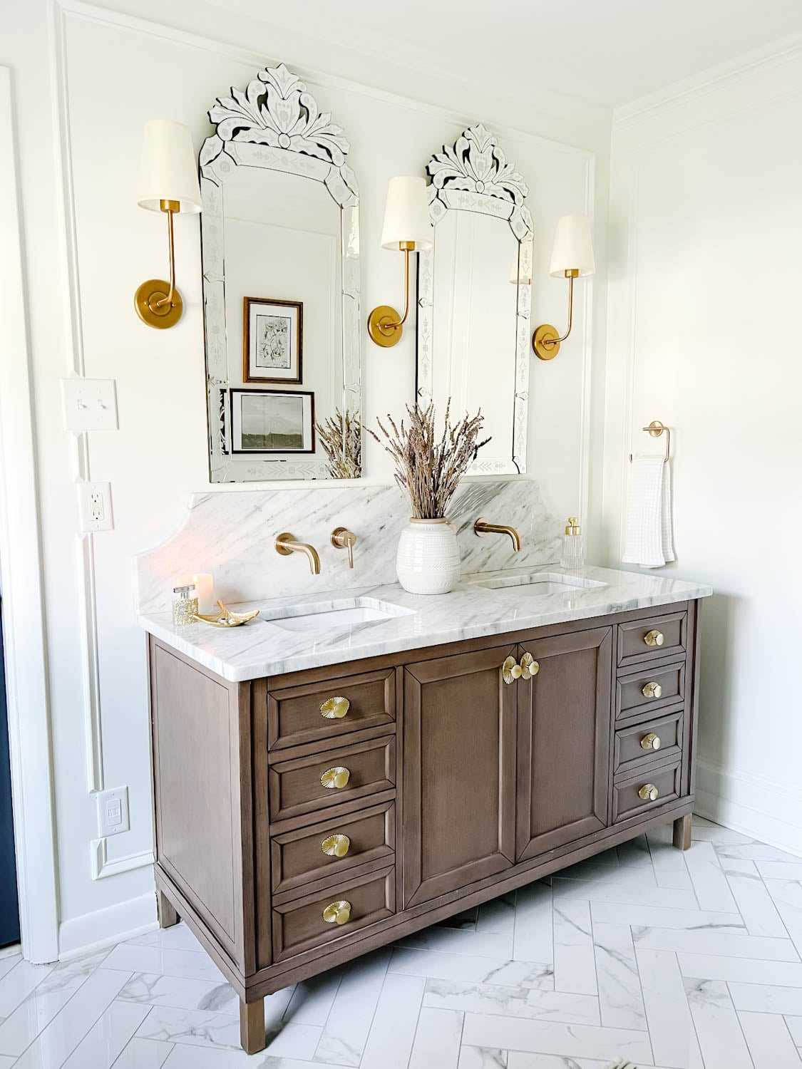 wooden bathroom vanity with marble countertop and scalloped backsplash