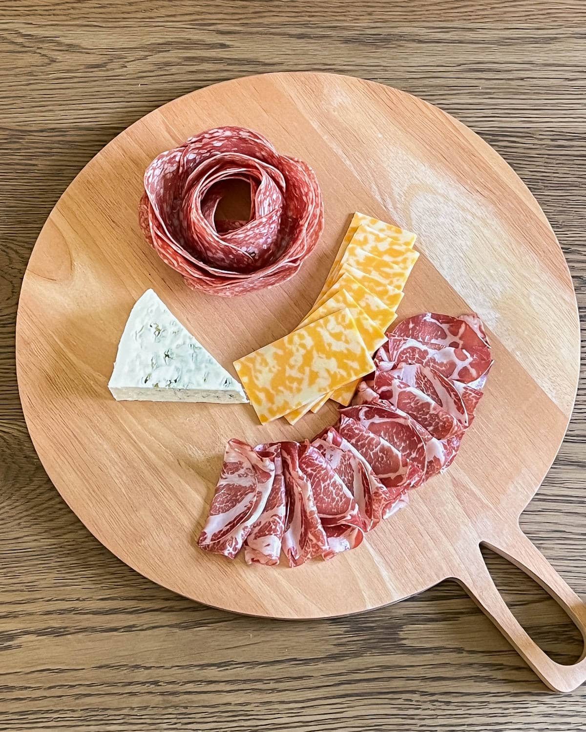 simple charcuterie board with cured meat and cheese added