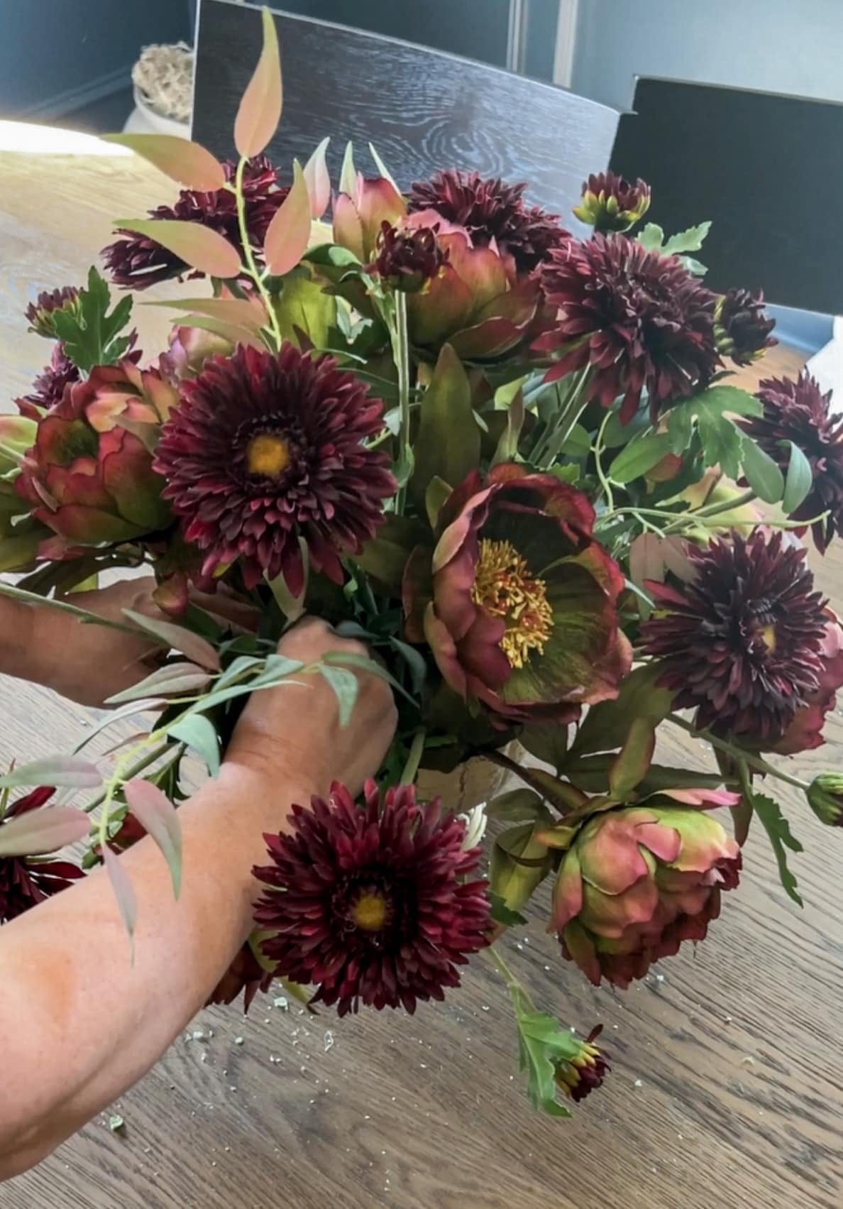 filling leaves into a fall centerpiece