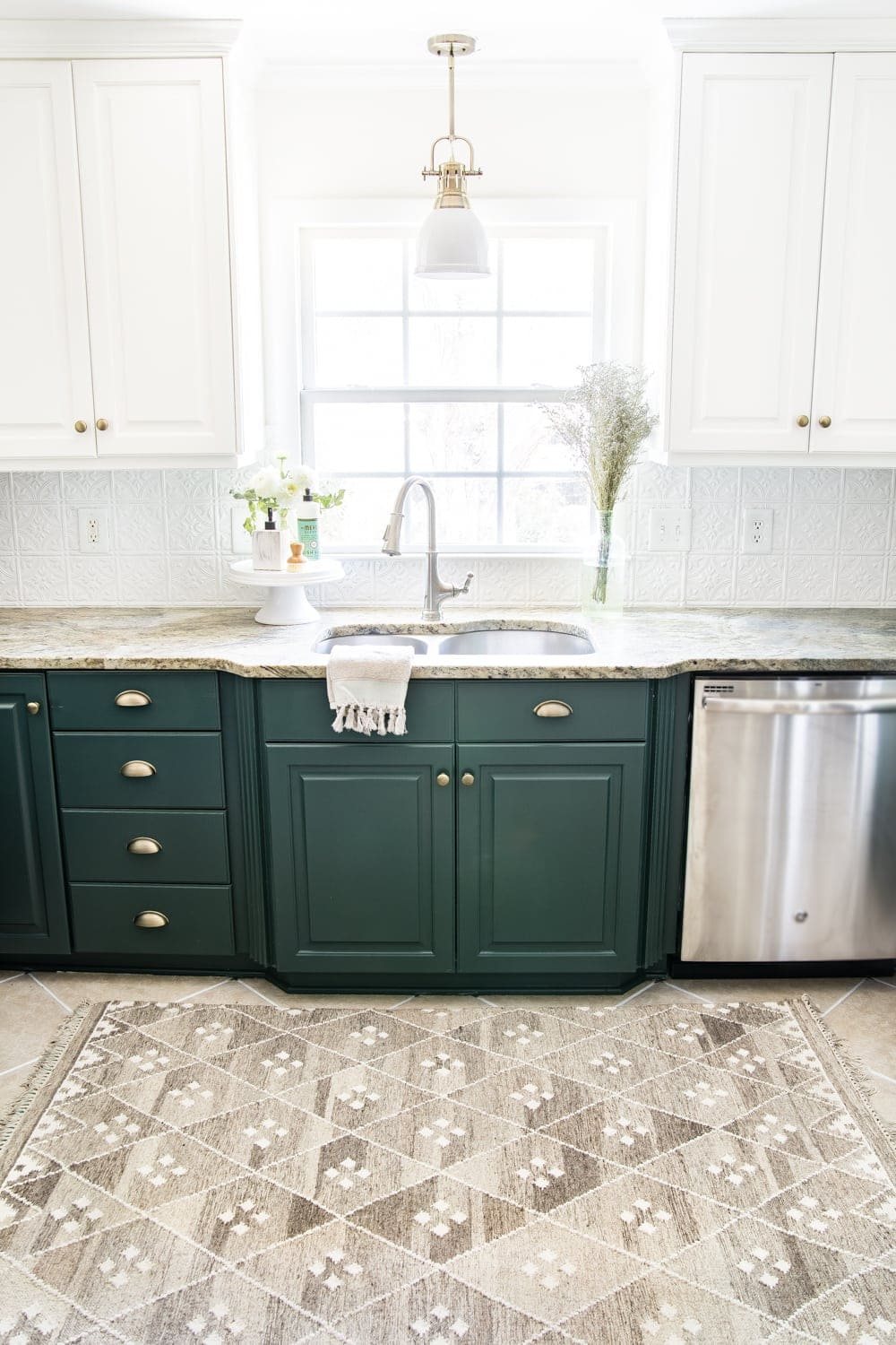 deep green kitchen cabinets with DIY pressed tin ceiling tile backsplash and layered memory foam kitchen rug
