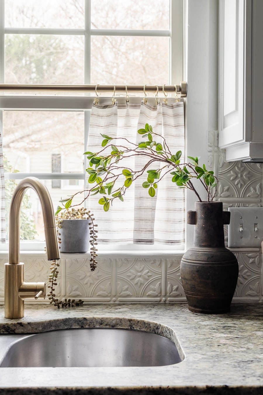 ticking stripe cafe curtains in a kitchen window