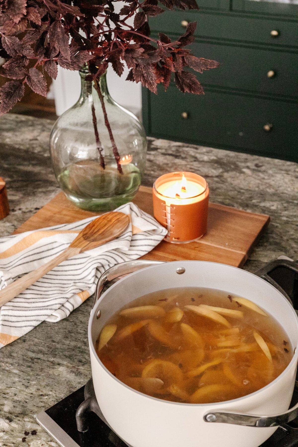 stovetop potpourri with vase of fall leaves to make your house smell good naturally