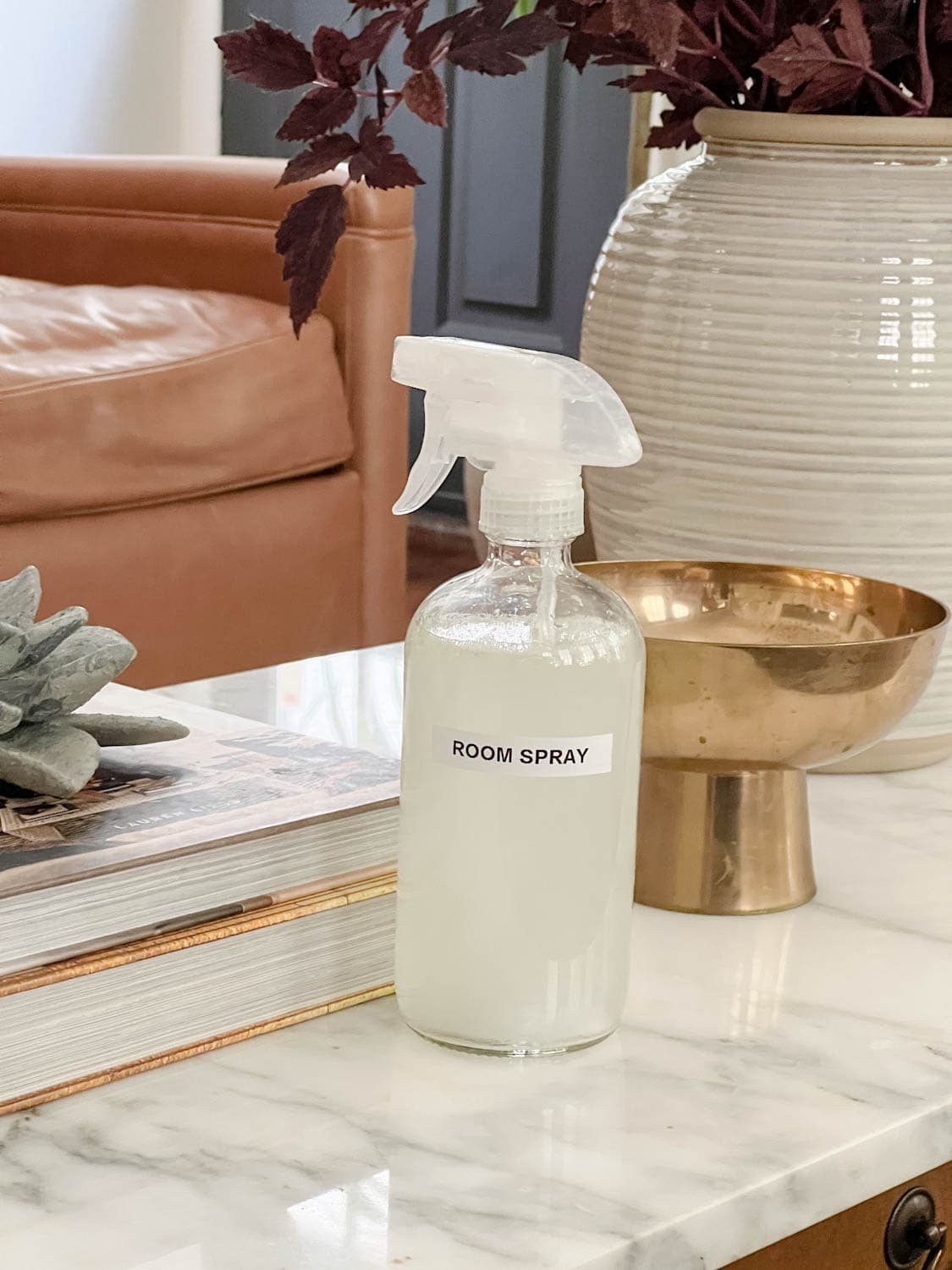 spray bottle of room spray on a living room coffee table