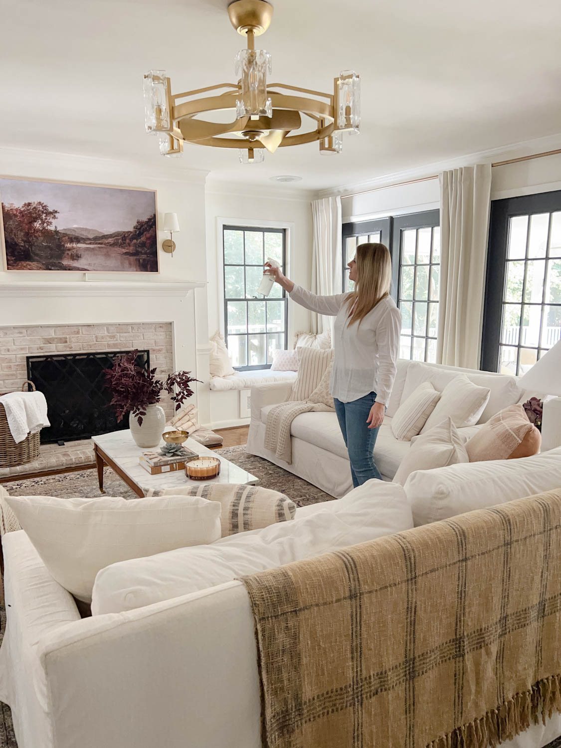 spritzing room spray in a living room