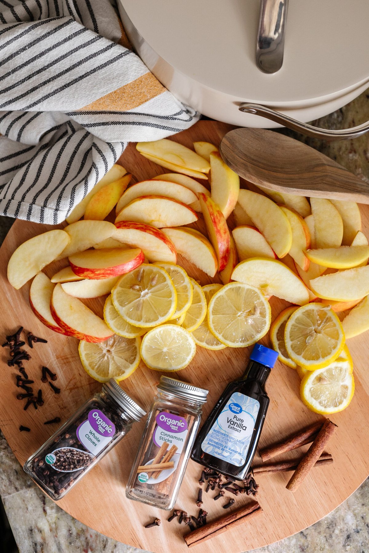 apples, lemons, cloves, cinnamon sticks, and vanilla extract for DIY stovetop potpourri