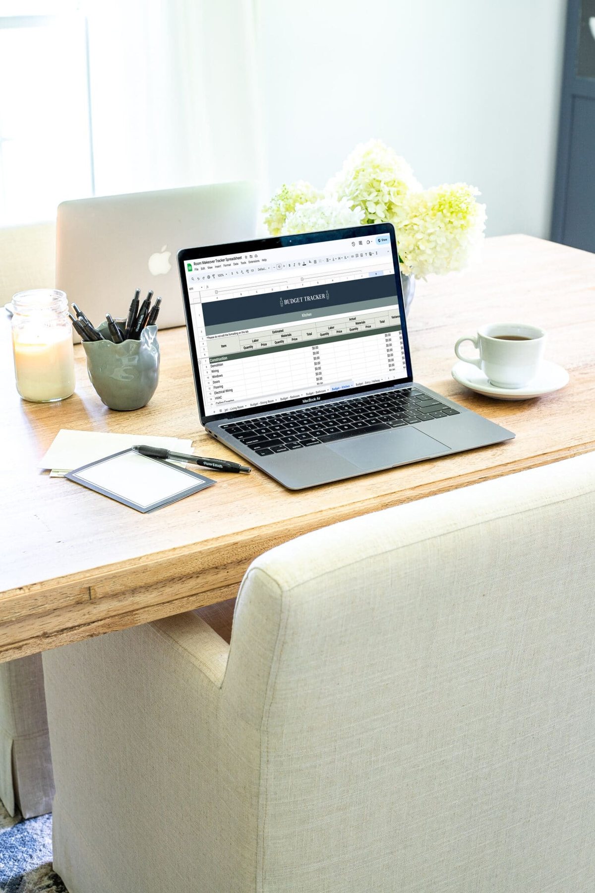 laptop with remodel budget tracking spreadsheet