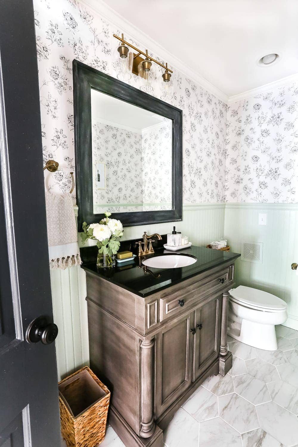 powder room before with black and white floral wallpaper and aqua beadboard