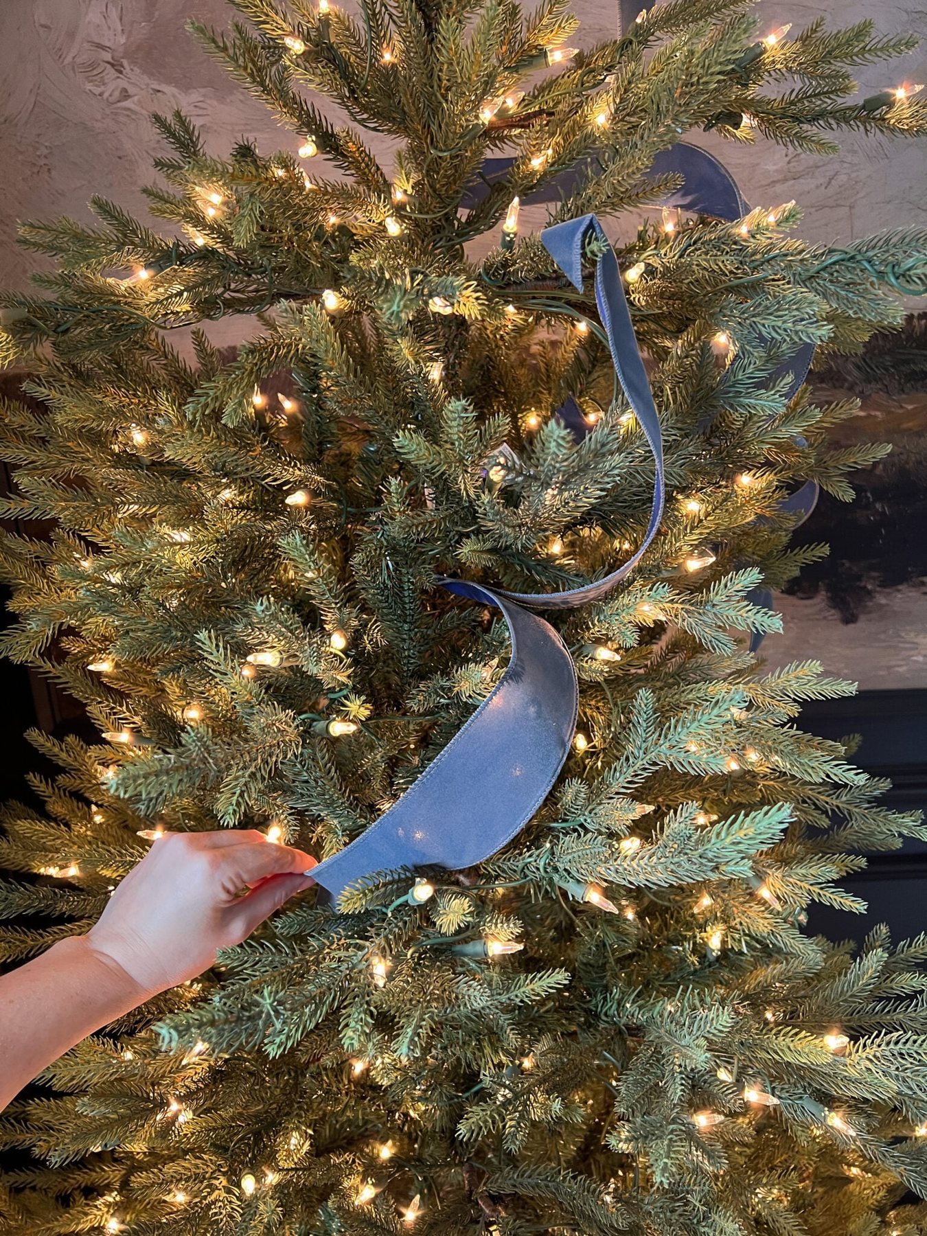 tucking ribbon piece between branches