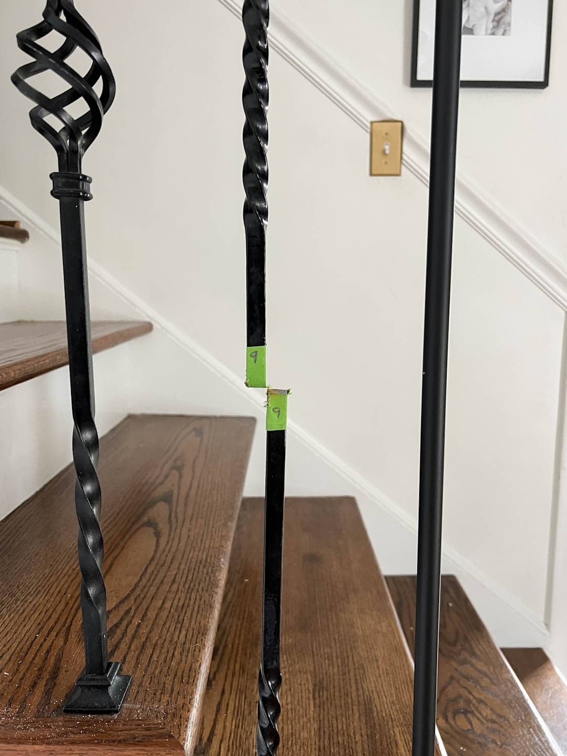 painters tape used to cut old stair balusters before removal