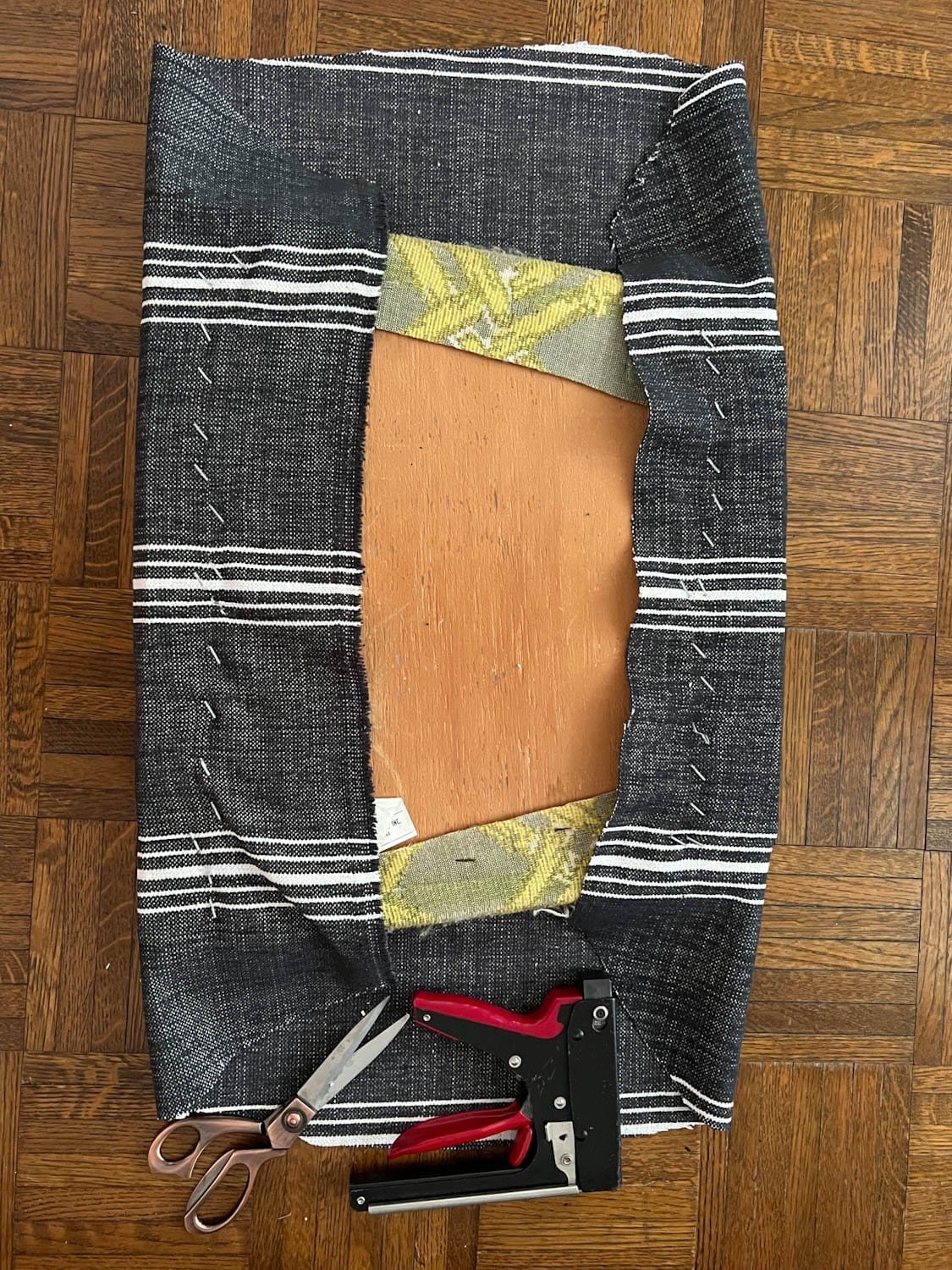 two sides of reupholstering dining chair seat using a staple gun