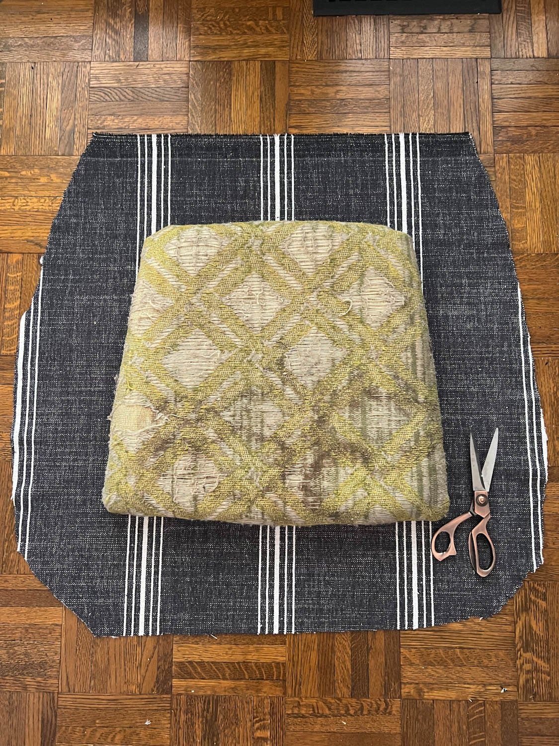 old dining chair seat on cut out upholstery fabric