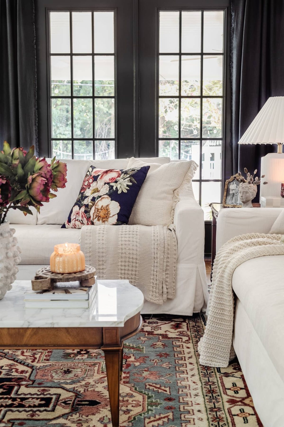 white living room sofas with navy floral pillow