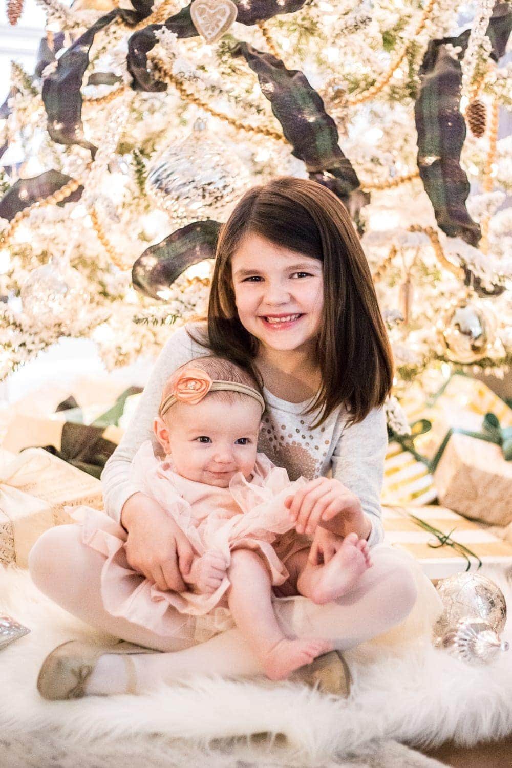 family Christmas photos in front of a tree