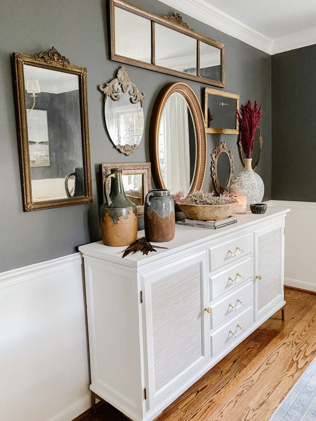 white painted buffet and antique mirror gallery wall