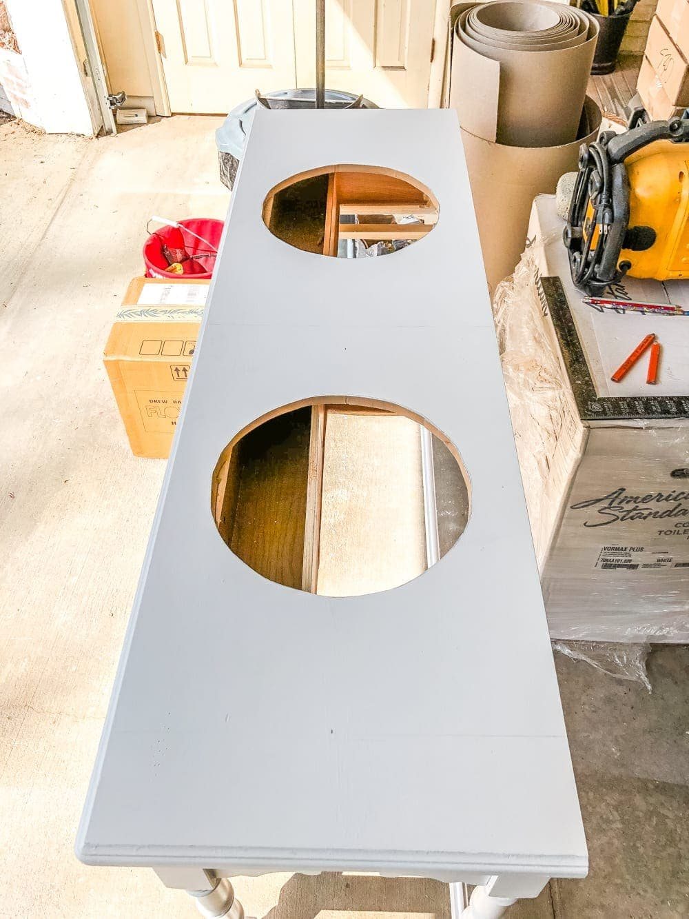 How to Turn a Console Table Into a Bathroom Vanity | unigumushane.com - A tutorial for how to reconstruct a console table to repurpose as a bathroom vanity and leave drawers functional underneath sinks.