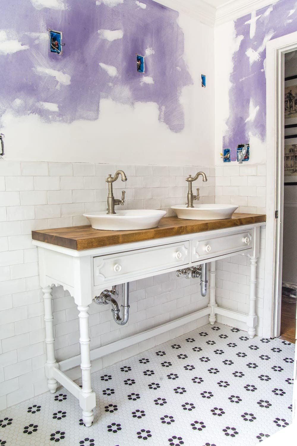 How to Turn a Console Table Into a Bathroom Vanity | unigumushane.com - A tutorial for how to reconstruct a console table to repurpose as a bathroom vanity and leave drawers functional underneath sinks.
