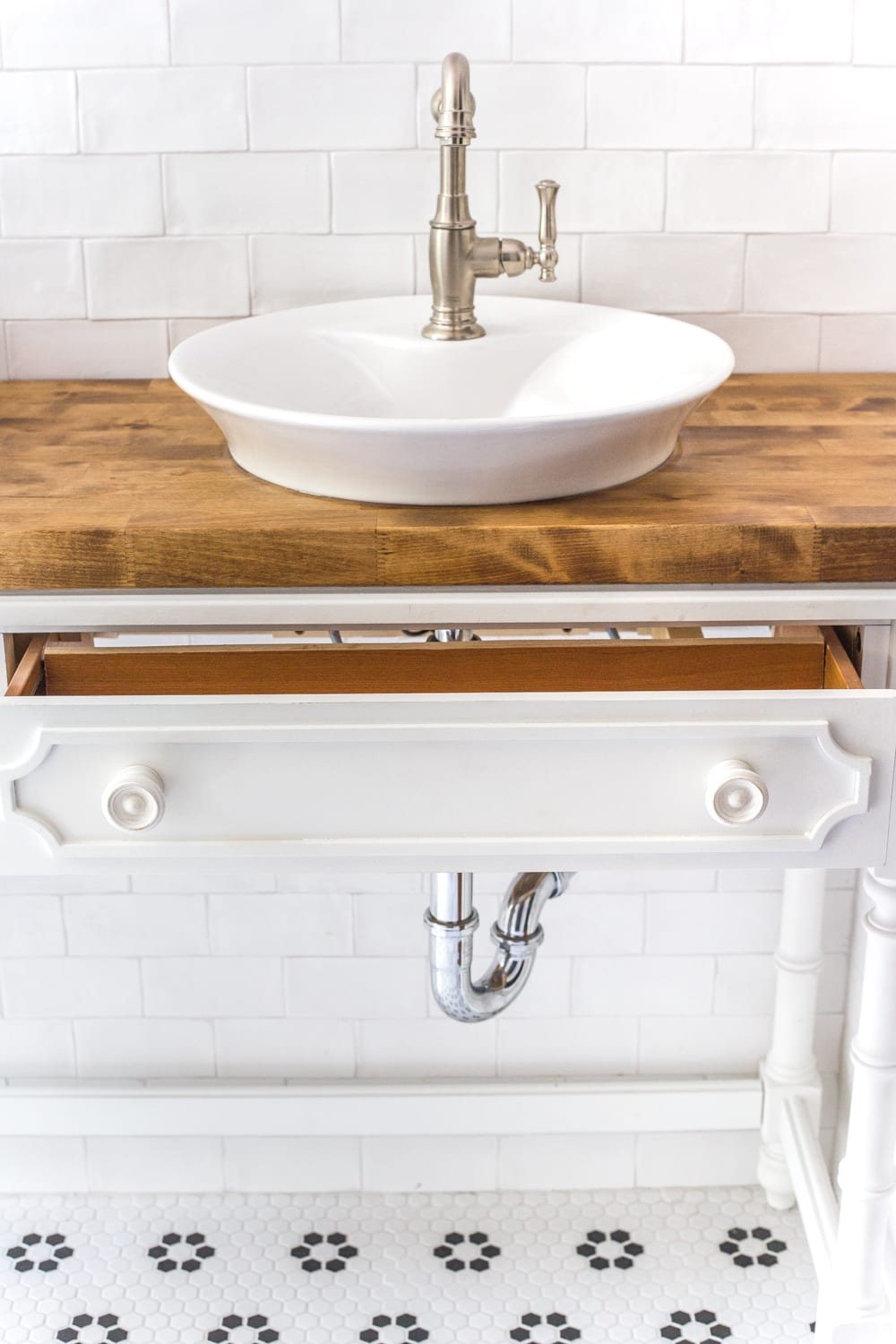 How to Turn a Console Table Into a Bathroom Vanity | unigumushane.com - A tutorial for how to reconstruct a console table to repurpose as a bathroom vanity and leave drawers functional underneath sinks.