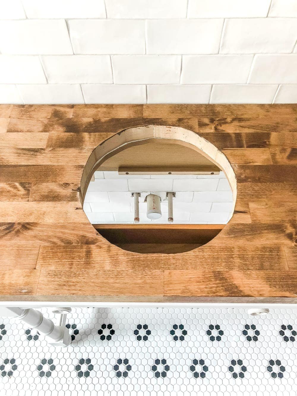 How to Turn a Console Table Into a Bathroom Vanity | unigumushane.com - A tutorial for how to reconstruct a console table to repurpose as a bathroom vanity and leave drawers functional underneath sinks.