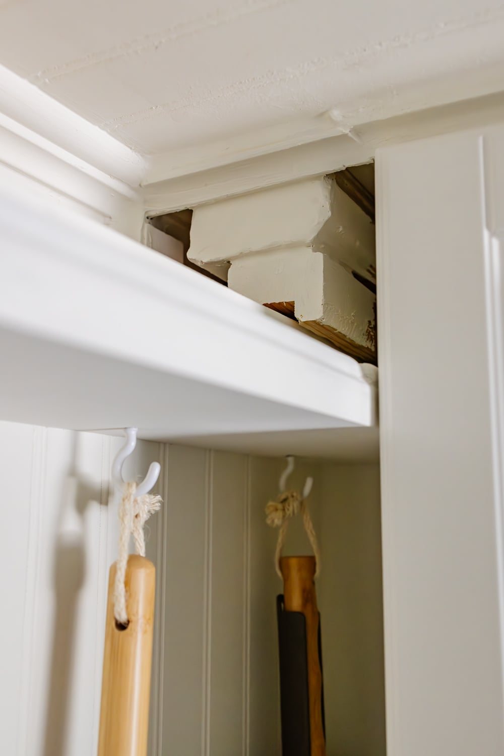hidden diy broom cupboard and cleaning supply storage in a laundry room