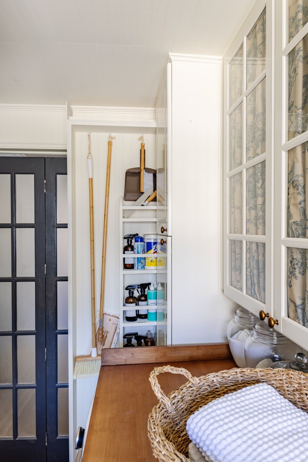 hidden diy broom cupboard and cleaning supply storage in a laundry room