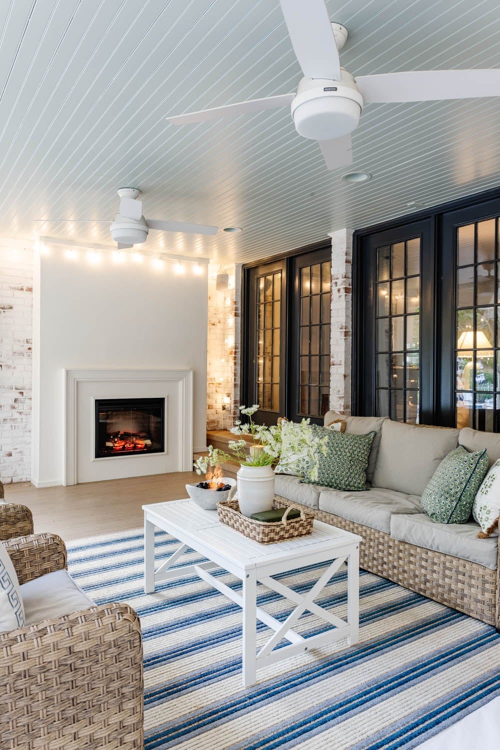 outdoor living room with fireplace on a back porch