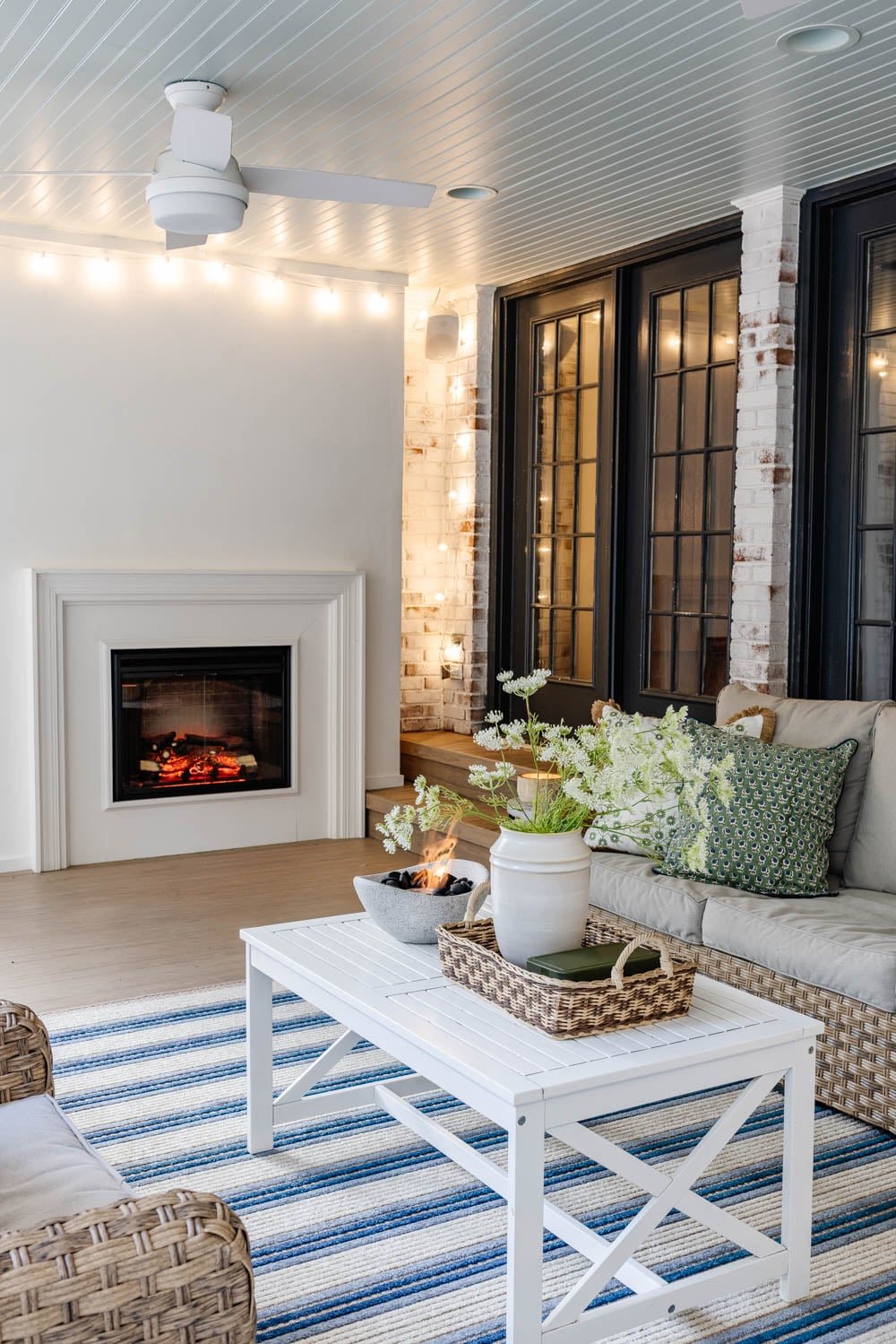 outdoor living room with fireplace on a back porch