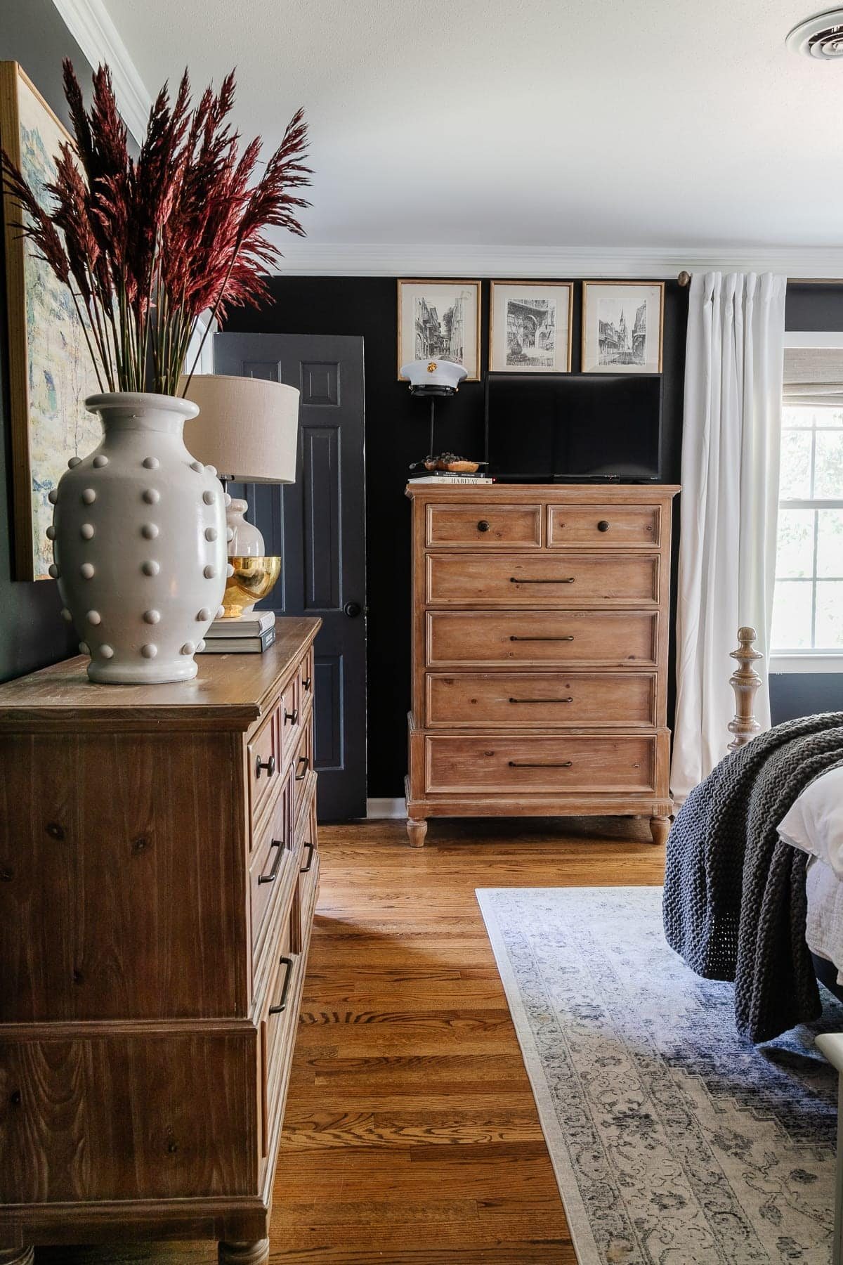 black bedroom with wood furniture decorated for fall