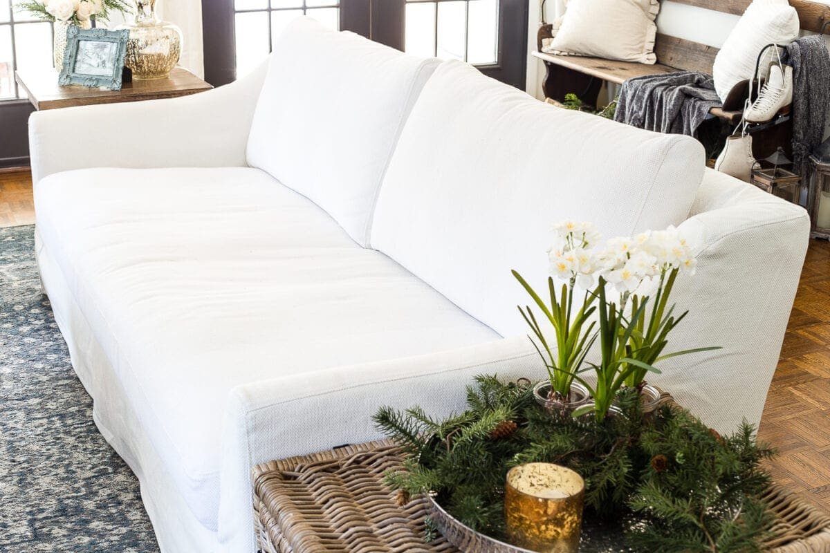 A complete review the IKEA Farlov sofa- how it holds up after 8 months with 2 dogs and a preschooler, the pros and cons of owning one, and tips to keep it looking bright white. #sofa #ikea #farlov #slipcover #furniture #livingroom