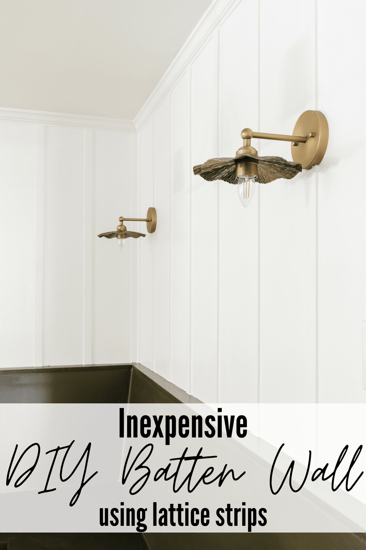 A DIY batten wall behind brass vintage sconces above a green banquette bench