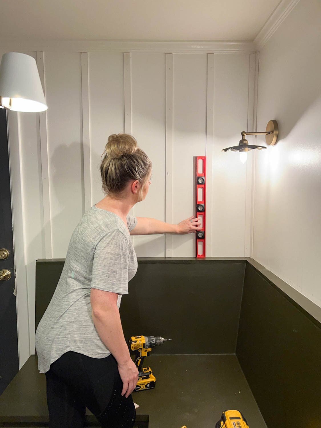 checking with a level to make sure lattice strips are perpendicular