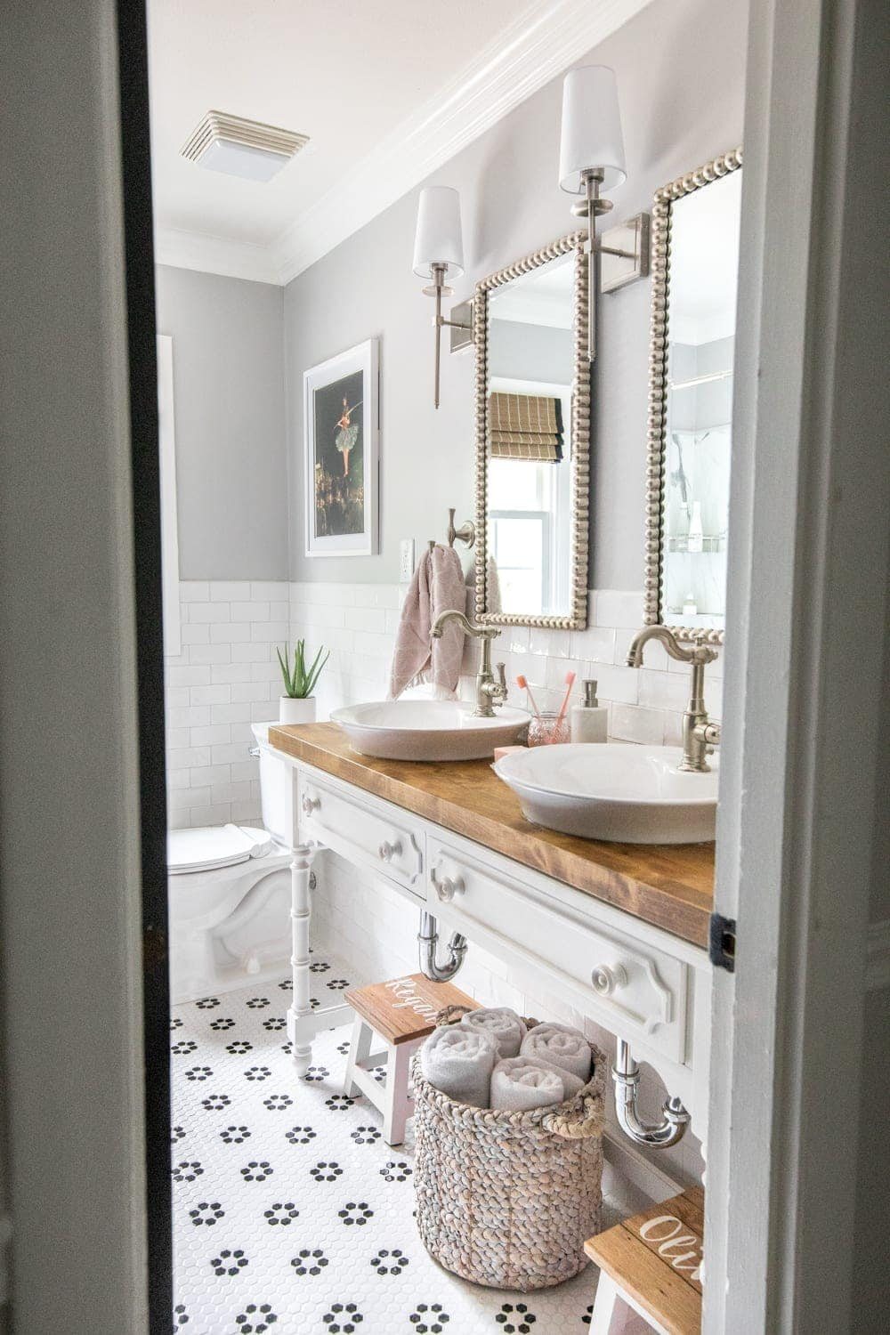 Whimsical, classic kids bathroom makeover | open vanity table with step stools and vessel sinks