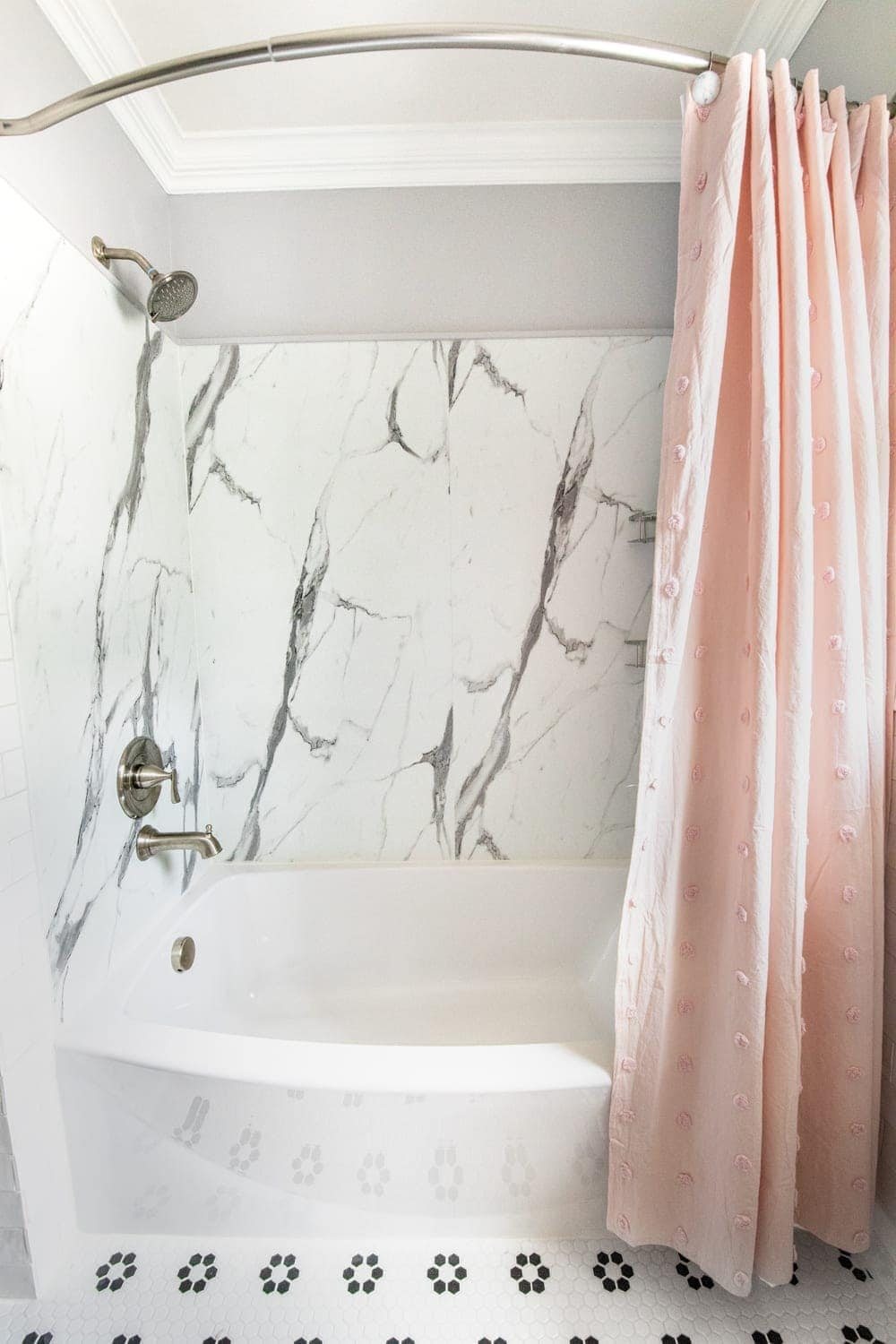 Whimsical, classic kids bathroom makeover | faux marble shower from American Standard Passage Collection and curved tub
