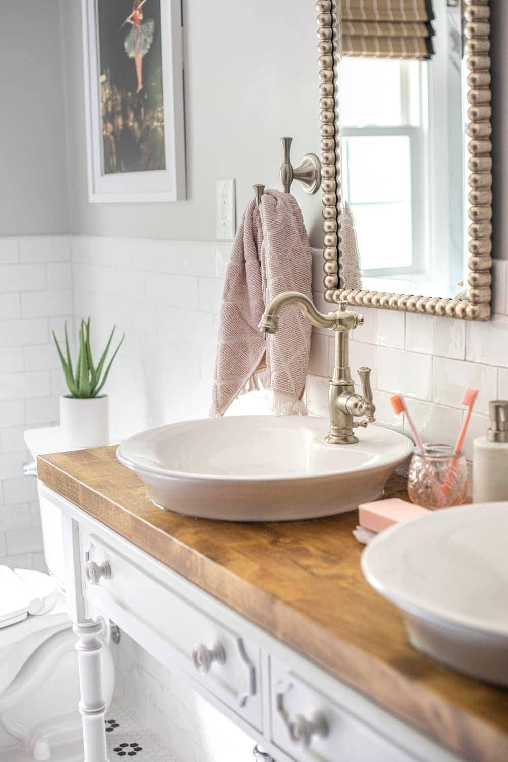 Whimsical, classic kids bathroom makeover | vessel sinks on a converted console table for a bathroom vanity